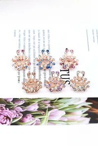 Detail showing mini crystal crown hair clips in six colors with rose gold finish