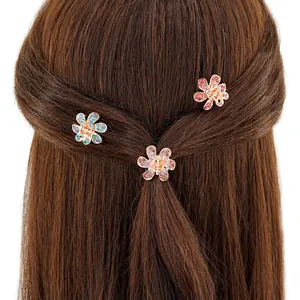 Mini pinces à cheveux florales avec strass et cristaux sur fond de cheveux foncés
