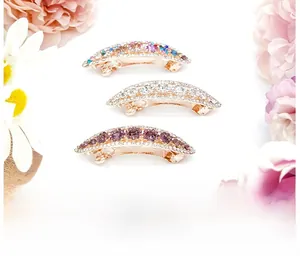 Detailed view of three mini spring hair clips with sparkling crystals and metal base