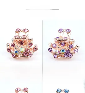 Macro shot of colorful rhinestone mini crown hair clips in rose gold metal finish