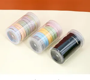 Three jars of colorful seamless high elastic hair ties in striped and solid macaron tones