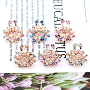 Elegant mini crown hair claws with colorful crystals on a stylish floral background