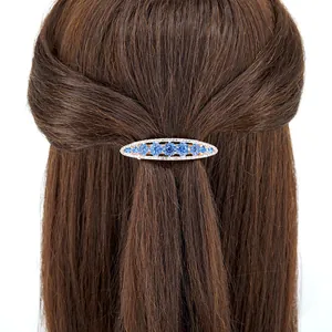Blue crystal floral hair clip with rhinestones on brown hair for side or ponytail styling