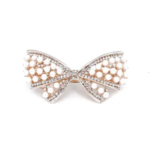Barrette à cheveux nœud doré avec perles blanches et cristaux étincelants