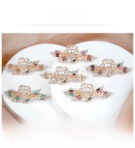 Detailed set of five floral crystal hair clips with sparkling rhinestones and gold alloy base