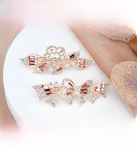 Detail of rose gold hair clips with crystals and zircon in flower and bow designs