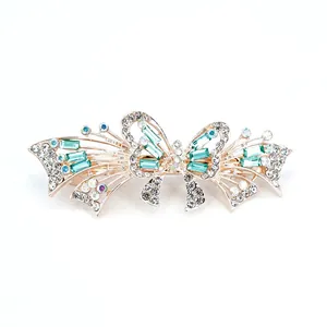 Elegant rose gold bow hair clip with mint green crystals and sparkling rhinestones