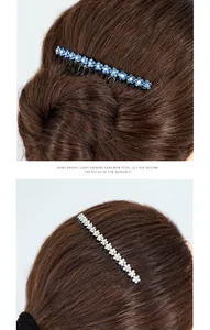 Detail of floral crystal hair comb featuring blue and white rhinestones on dark hair