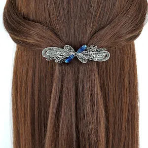 Vintage gunmetal hair clip with dark grey crystals and blue rhinestones on brown hair