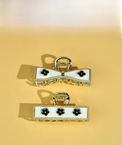 Detailed macro view of vintage bow and rectangular alloy hair clips with clover pattern
