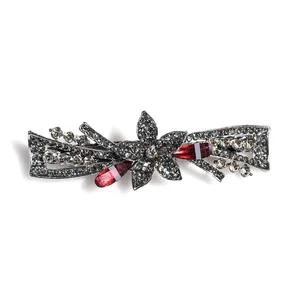 Retro gun black spring hair clip with rhinestones and central flower motif in vintage style