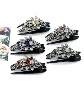 Detailed set of five crystal flower hair claws in navy, wine red, and champagne tones