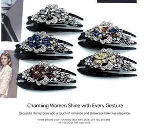 Detailed view of elegant swallowtail hair claws with sparkling rhinestones and floral design