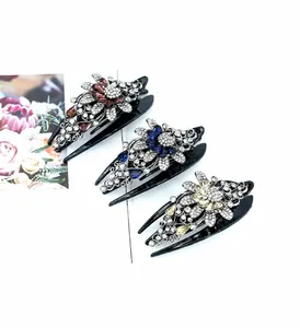 Detailed close-up of floral rhinestones on elegant swallowtail hair claw clips
