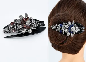Detail of floral hair claw clip with intricate red and blue rhinestones for women