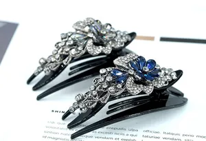 Close-up of elegant floral rhinestone hair claw clips in navy blue and silver colors