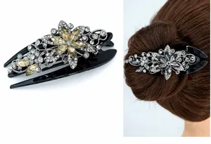 Detail of vintage flower hair claw clip with champagne rhinestones and black metal base