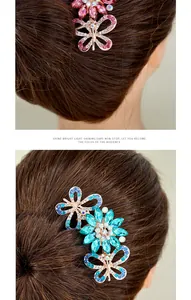 Detail of elegant crystal butterfly and flower hair comb with pink and blue rhinestones
