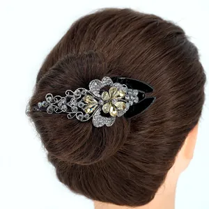Elegant floral rhinestone claw clip with black base and crystals for bun hairstyles