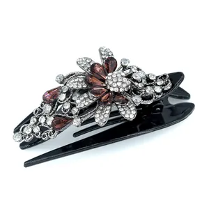 Elegant swallowtail hair claw with metallic flowers and amber rhinestones on black base