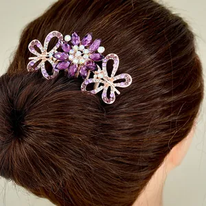 Elegant butterfly flower hair comb with purple rhinestones on a rose gold metal base