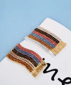 Macro view of colorful rhinestone-encrusted hairpins arranged on a white card.