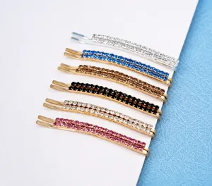 Detail of six sparkling rhinestone hair pins in various colors on a white display card