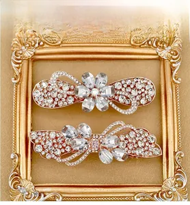 Detailed macro shot of floral and bow rhinestone hair clips in vintage gold frames