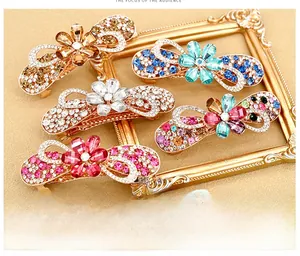 Detailed close-up of crystal flower hair clips featuring elegant rhinestone inlay on alloy