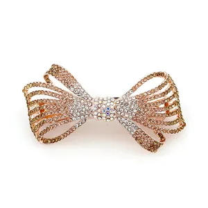 Pince à cheveux nœud en cristal avec strass champagne sur base dorée rose
