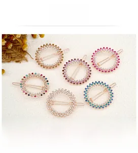 Set of six round rhinestone hair clips in various colors with elegant gold metal finish
