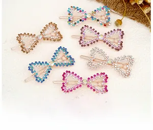 Detail of six colorful rhinestone butterfly hair clips with sparkling crystal metal base
