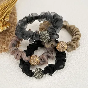Neutral mesh scrunchies with rhinestone ball charms in black, grey, and champagne colors