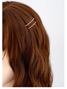 Dettaglio di fermagli in cristallo rosa su capelli mossi per un tocco di stile laterale