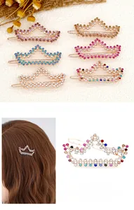 Detail of rose gold crown hair clips with colorful rhinestones in a macro view