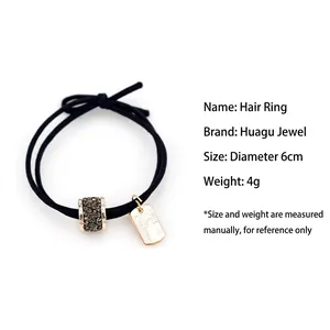 Élastique à cheveux noir double brin avec cylindre doré serti de cristaux et plaque