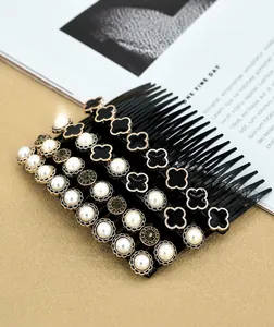 Detail of French vintage hair comb set with pearls, rhinestones and clover motifs