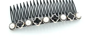 Detailed close-up of a French vintage hair comb with pearls and clover charms