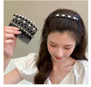 Close-up of elegant hair comb set with black clover motifs and faux pearls