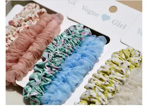Detailed close-up of colorful organza and floral scrunchies on a white display card