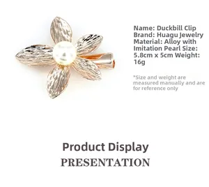 Detail of golden five-petal flower hair clip with hammered texture and faux pearl center