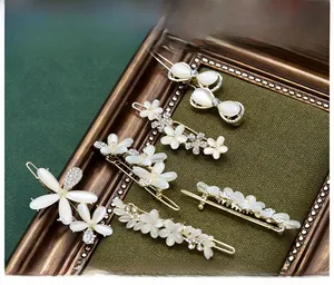 Detailed view of cat-eye stone floral hair clips with rhinestones on dark velvet