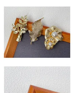 Detail of gold metal branch hairpins with pearls and crystals on a rustic background