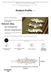 Detail view of champagne gold cat eye flower hair clip with size and weight specs