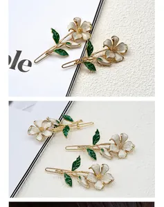 Detail of floral hair clips with creamy white petals and gold-tone metal finish