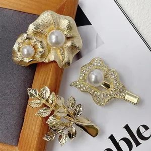 Three-piece vintage gold hair clip set with pearls, floral designs, and rhinestones