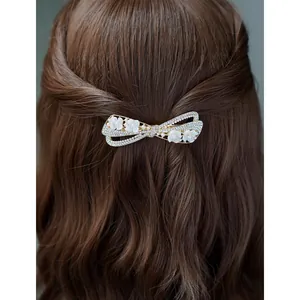 Elegant bow hair clip with pearls and rhinestones on gold alloy for women's hairstyles