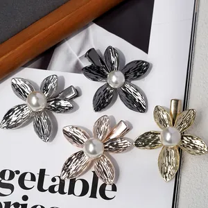 Elegant four-color metal flower hair clips with central pearl accents on duckbill pins