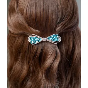Barrette à cheveux élégante avec nœud en cristal bleu sur alliage argenté et strass blancs