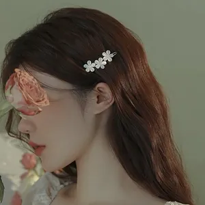Elegant cat eye stone hair clip with white five-petal flowers and sparkling rhinestones